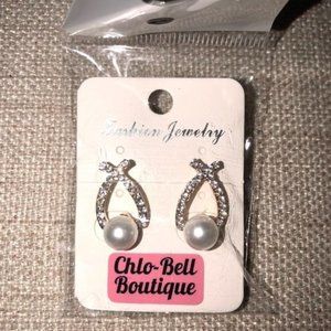 Faux Pearl and rhinestone stud earrings in gold colored metal.